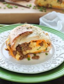 This Breakfast Stuffed French Bread is like a huge breakfast sandwich stuffed with soft scrambled eggs, meaty sausage, and sharp cheddar cheese inside a fresh baked loaf of French bread. (Substitute your favorite meats or cheeses to create your own!)