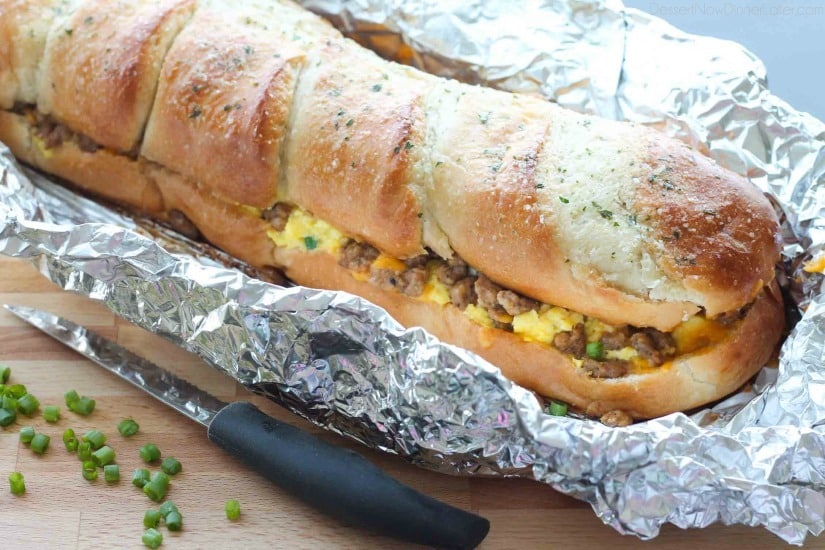 This Breakfast Stuffed French Bread is like a huge breakfast sandwich stuffed with soft scrambled eggs, meaty sausage, and sharp cheddar cheese inside a fresh baked loaf of French bread. (Substitute your favorite meats or cheeses to create your own!)