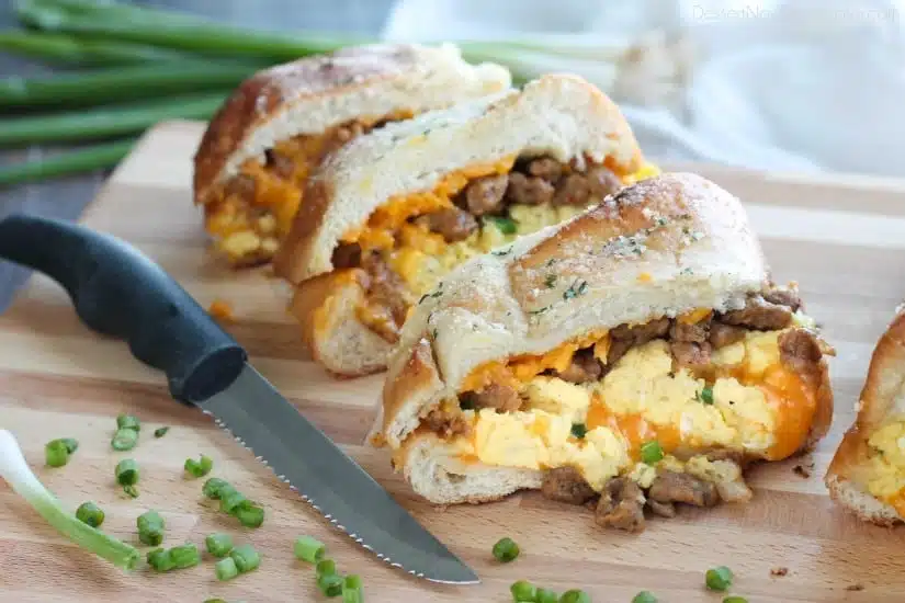 This Breakfast Stuffed French Bread is like a huge breakfast sandwich stuffed with soft scrambled eggs, meaty sausage, and sharp cheddar cheese inside a fresh baked loaf of French bread. (Substitute your favorite meats or cheeses to create your own!)