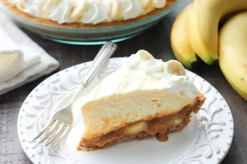 This Caramel Banana Cream Pie is heavenly and so easy to make! With caramel and freshly sliced bananas on the bottom of a homemade graham cracker crust, and a rich, creamy pudding layer on top, this banana cream pie is sure to be your new favorite dessert!