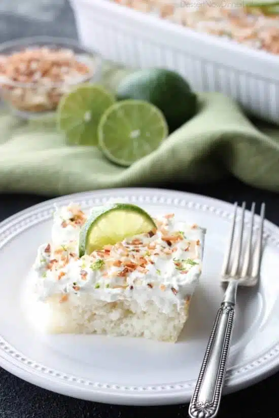 Coconut Lime Poke Cake - a fluffy, white, lime-infused cake that is soaked with coconut cream, and topped with sweetened whipped cream, toasted coconut, and lime zest. It's super moist and full of tropical flavors!