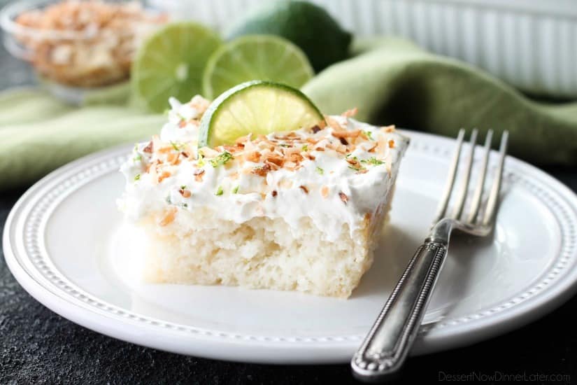 Coconut Lime Poke Cake - a fluffy, white, lime-infused cake that is soaked with coconut cream, and topped with sweetened whipped cream, toasted coconut, and lime zest. It's super moist and full of tropical flavors!