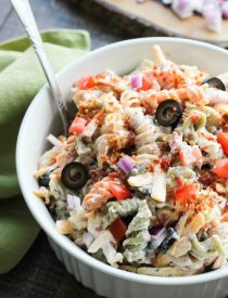 Bacon Ranch Pasta Salad is perfect for BBQ's and all your summer get togethers. It's loaded with pasta, bacon, cheese, olives, tomatoes, and onion then tossed with a simple, creamy ranch dressing.