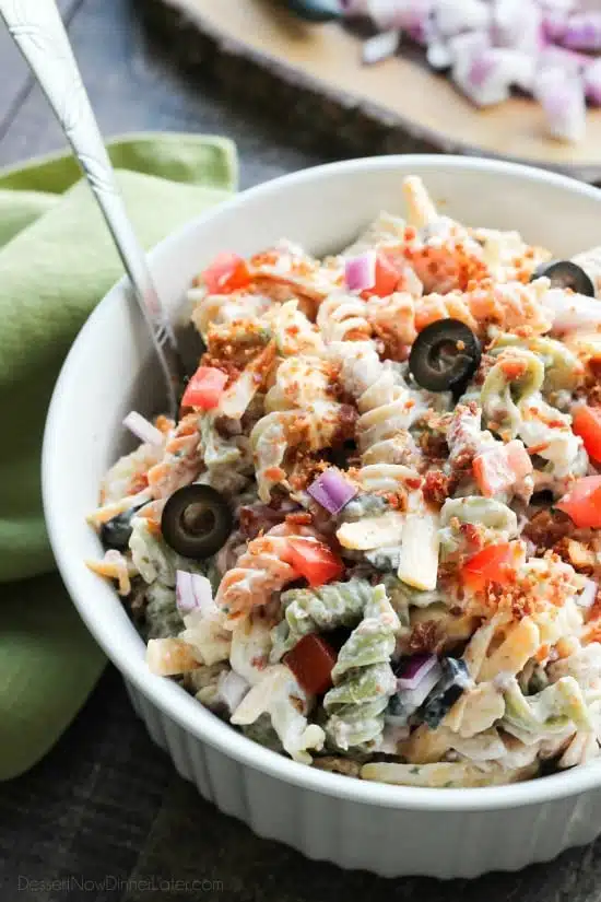 Bacon Ranch Pasta Salad is perfect for BBQ's and all your summer get togethers. It's loaded with pasta, bacon, cheese, olives, tomatoes, and onion - then tossed with a simple, creamy ranch dressing. 