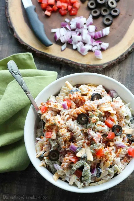 Bacon Ranch Pasta Salad is perfect for BBQ's and all your summer get togethers. It's loaded with pasta, bacon, cheese, olives, tomatoes, and onion - then tossed with a simple, creamy ranch dressing. 