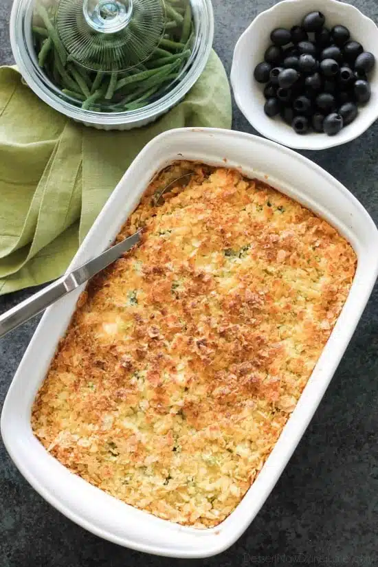 These funeral potatoes are creamy and cheesy, with sour cream, onions, extra spices, and a crunchy potato chip topping. Always a hit, this cheesy potato casserole will get gobbled up quick! Great for potlucks and holidays.