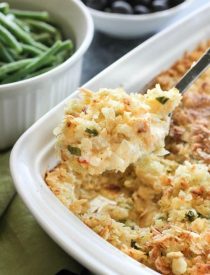 These funeral potatoes are creamy and cheesy, with sour cream, onions, extra spices, and a crunchy potato chip topping. Always a hit, this cheesy potato casserole will get gobbled up quick! Great for potlucks and holidays.