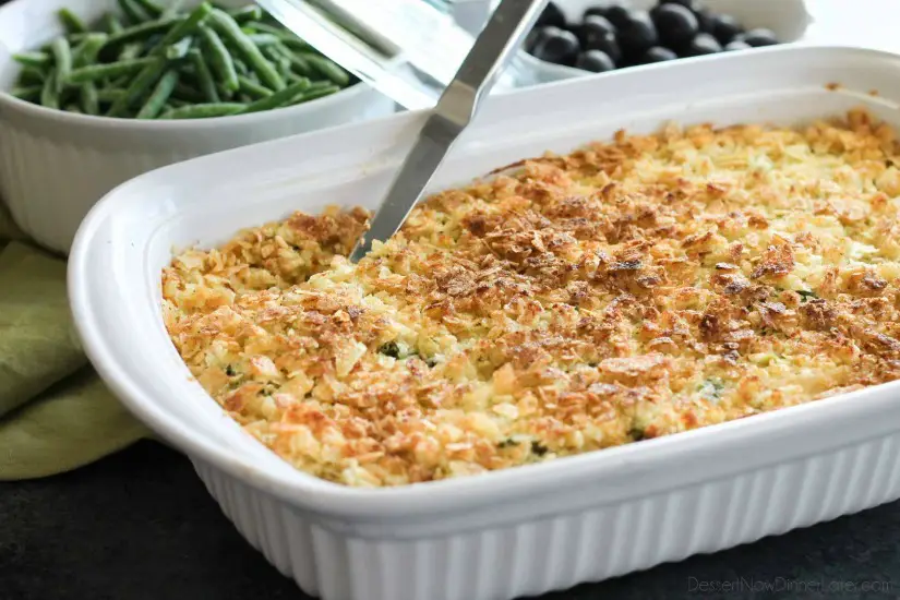 These funeral potatoes are creamy and cheesy, with sour cream, onions, extra spices, and a crunchy potato chip topping. Always a hit, this cheesy potato casserole will get gobbled up quick! Great for potlucks and holidays.
