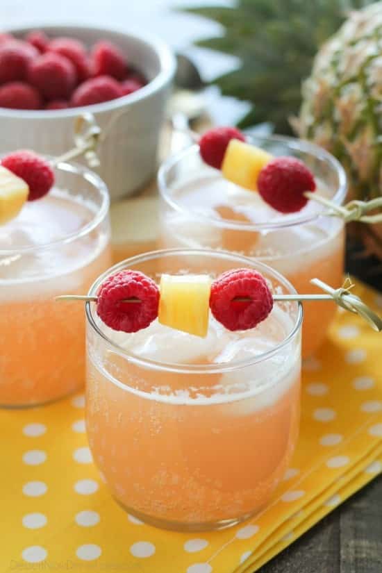 Raspberry Pineapple Punch is fruity, fizzy, and family friendly. Great for your summer party or baby shower.