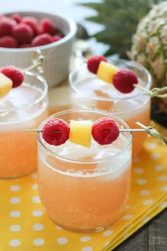 Raspberry Pineapple Punch is fruity, fizzy, and family friendly. Great for your summer party or baby shower.