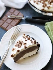 This no bake cheesecake has two layers of light and smooth cheesecake -- creamy vanilla and decadent chocolate, layered inside a chocolate cookie crust, and topped with sweetened whipped cream and chocolate shavings. It's an easy and delicious summer dessert!