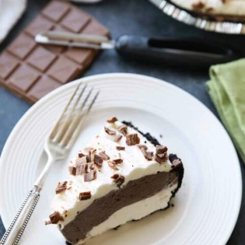 This no bake cheesecake has two layers of light and smooth cheesecake -- creamy vanilla and decadent chocolate, layered inside a chocolate cookie crust, and topped with sweetened whipped cream and chocolate shavings. It's an easy and delicious summer dessert!