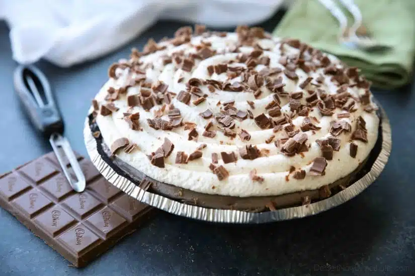 This no bake cheesecake has two layers of light and smooth cheesecake -- creamy vanilla and decadent chocolate, layered inside a chocolate cookie crust, and topped with sweetened whipped cream and chocolate shavings. It's an easy and delicious summer dessert!