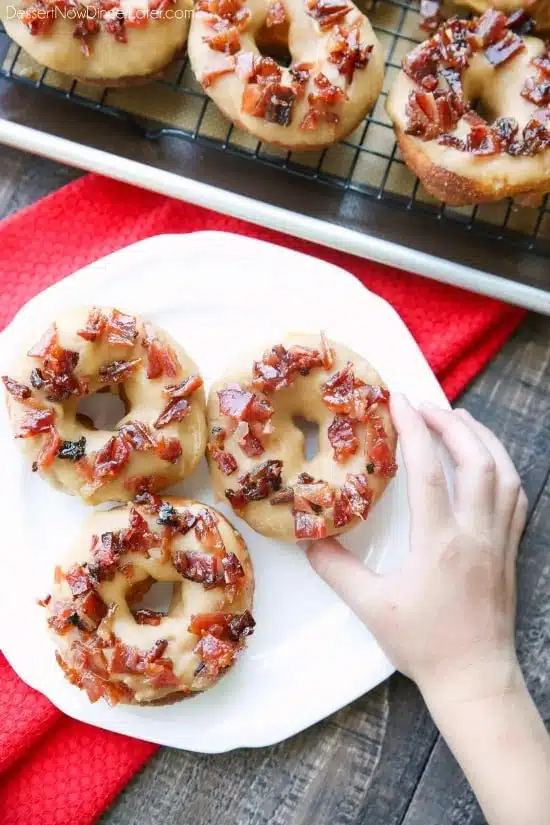 Maple Bacon Donuts are breakfast perfection! The salty bacon cuts through the sweetness of the maple and brown sugar glaze on top of a fluffy yeast donut.