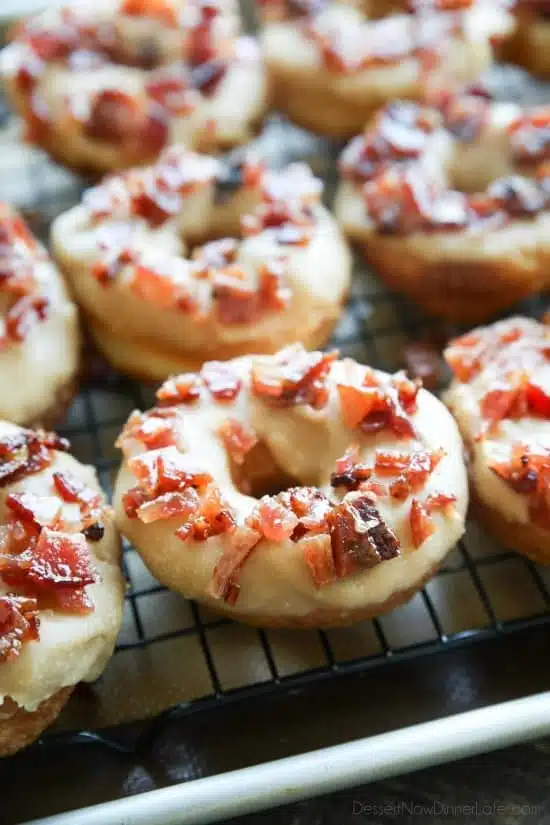 Maple Bacon Donuts are breakfast perfection! The salty bacon cuts through the sweetness of the maple and brown sugar glaze on top of a fluffy yeast donut.