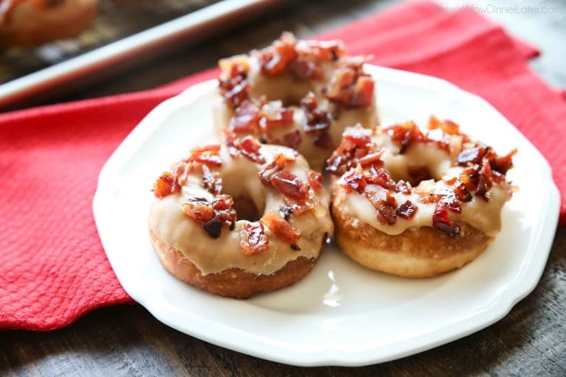 Maple Bacon Donuts are breakfast perfection! The salty bacon cuts through the sweetness of the maple and brown sugar glaze on top of a fluffy yeast donut.