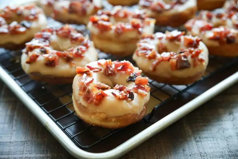 Maple Bacon Donuts are breakfast perfection! The salty bacon cuts through the sweetness of the maple and brown sugar glaze on top of a fluffy yeast donut.