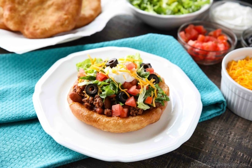 These easy Navajo Tacos (also known as Indian Fry Bread) are quick to whip up for dinner, smothered with a beef and bean taco filling, and finished with all the classic taco toppings. A fair food favorite made easily at home!