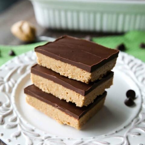 Easy No Bake Peanut Butter Bars taste a lot like a Reese's Peanut Butter Cup. The perfect party pleasing dessert with a sweet peanut butter base, and creamy chocolate ganache topping.