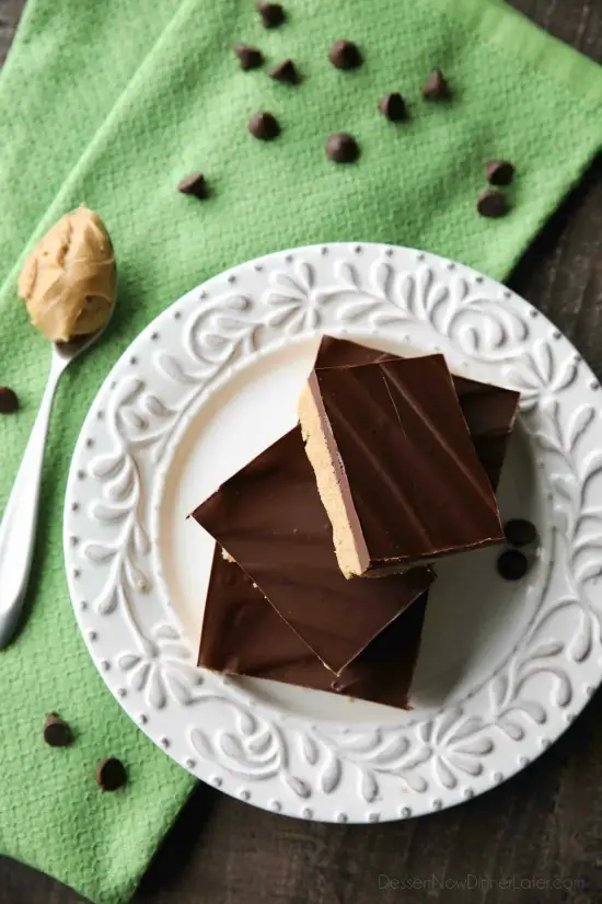 Easy No Bake Peanut Butter Bars taste a lot like a Reese's Peanut Butter Cup. The perfect party pleasing dessert with a sweet peanut butter base, and creamy chocolate ganache topping.