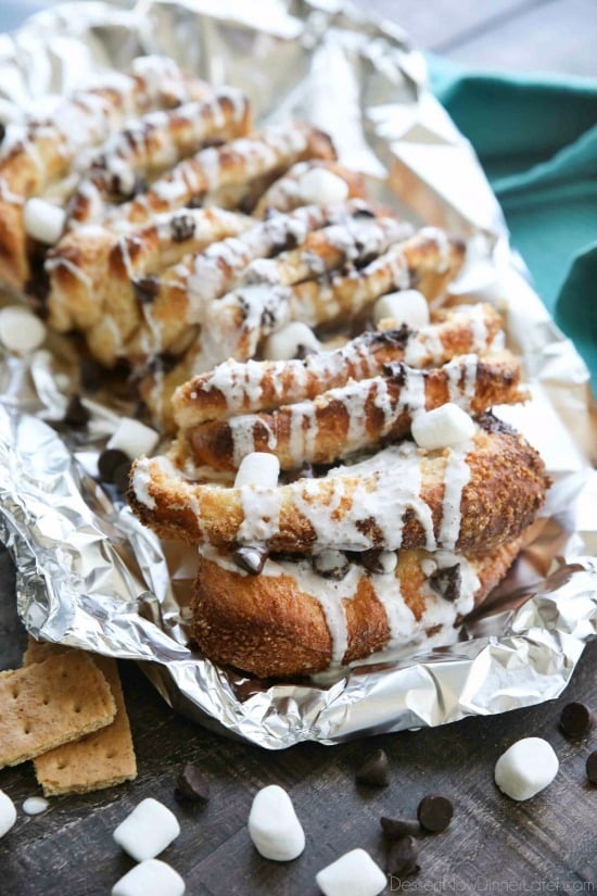 S'mores Pull Apart Bread is loaded with graham cracker crumbs, marshmallows, and chocolate chips, then topped off with a marshmallow glaze for a camping inspired dessert you can enjoy anytime!