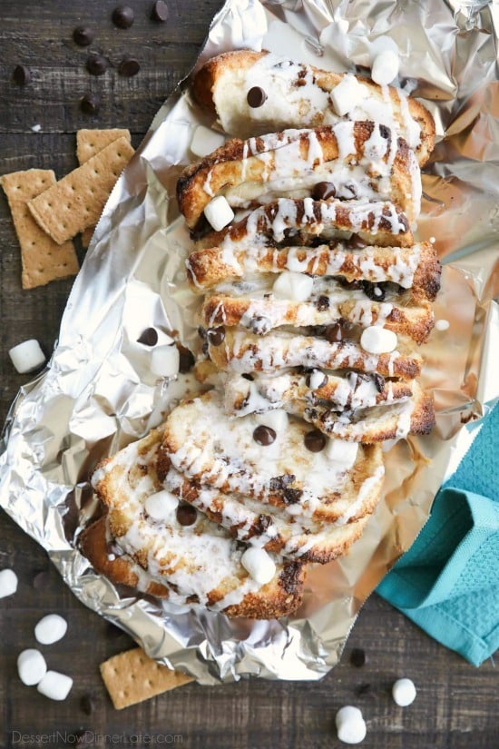 S'mores Pull Apart Bread is loaded with graham cracker crumbs, marshmallows, and chocolate chips, then topped off with a marshmallow glaze for a camping inspired dessert you can enjoy anytime!