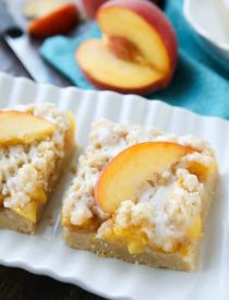 These Peach Crumb Bars are made with fresh summer peaches, sandwiched between a sweet buttery crust and crumb topping, with a hint of cinnamon, and are drizzled with a fresh almond (or vanilla) glaze. The most delicious summer dessert!