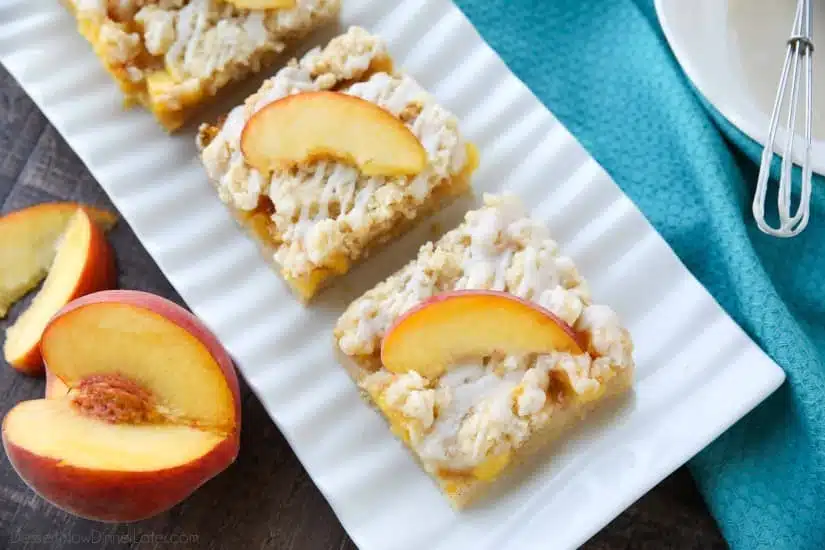 These Peach Crumb Bars are made with fresh summer peaches, sandwiched between a sweet buttery crust and crumb topping, with a hint of cinnamon, and are drizzled with a fresh almond (or vanilla) glaze. The most delicious summer dessert!