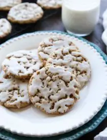 Old fashioned Iced Oatmeal Cookies are crisp on the outside, soft and chewy on the inside, with warm spices, and a light glaze on top. Perfect with a cold glass of milk!