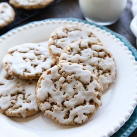 Old fashioned Iced Oatmeal Cookies are crisp on the outside, soft and chewy on the inside, with warm spices, and a light glaze on top. Perfect with a cold glass of milk!