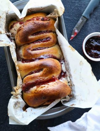 Intestines Bread is a fun halloween party food that makes you look twice. All it really is, is a sweet pull apart bread with cream cheese and raspberries.