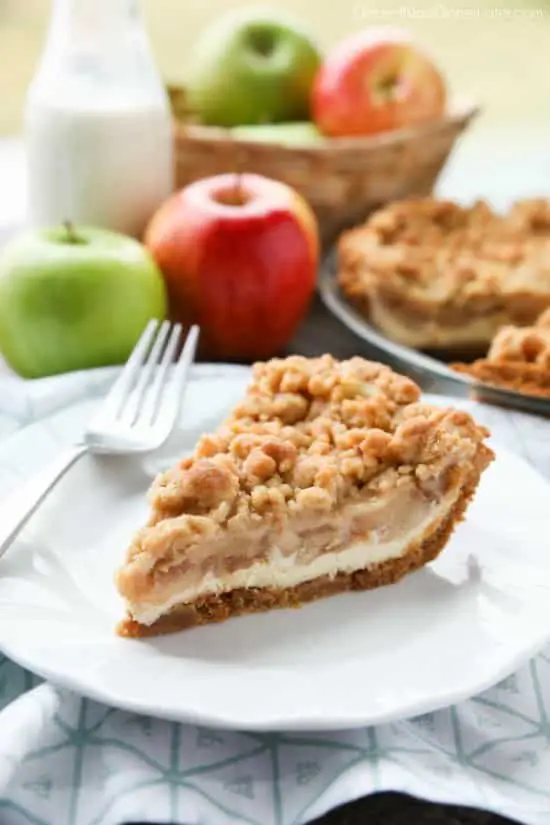 Apple Streusel Cheesecake Pie combines two dessert favorites with a graham cracker crust, creamy cheesecake layer, homemade apple pie filling, and crunchy streusel topping.