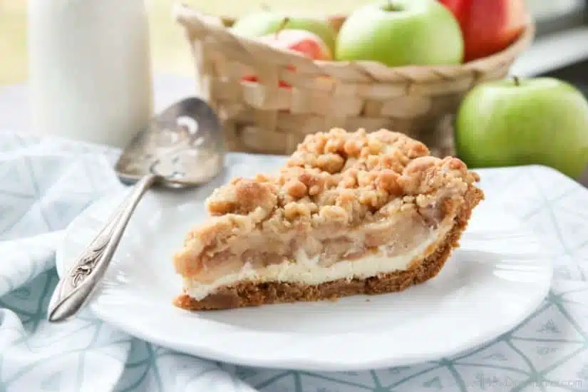 Apple Streusel Cheesecake Pie combines two dessert favorites with a graham cracker crust, creamy cheesecake layer, homemade apple pie filling, and crunchy streusel topping.