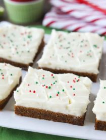 Gingerbread Cookie Bars have a soft and chewy, spiced molasses cookie base topped with the BEST cream cheese frosting. Add red and green sprinkles or nonpareils for a festive Christmas dessert!