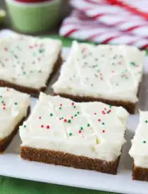 Gingerbread Cookie Bars have a soft and chewy, spiced molasses cookie base topped with the BEST cream cheese frosting. Add red and green sprinkles or nonpareils for a festive Christmas dessert!