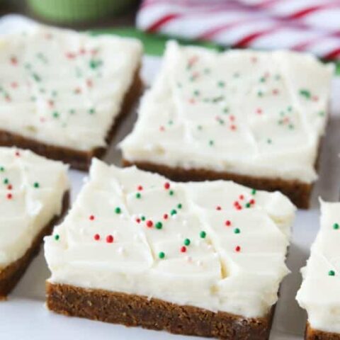 Gingerbread Cookie Bars have a soft and chewy, spiced molasses cookie base topped with the BEST cream cheese frosting. Add red and green sprinkles or nonpareils for a festive Christmas dessert!