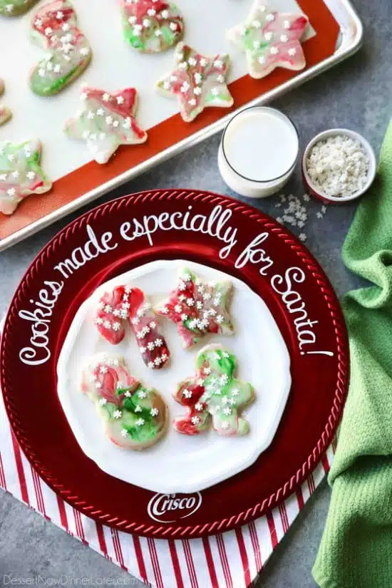 Swirled Christmas Sugar Cookies make cookie decorating easy! Simply swirl food coloring in a special glaze and dip the cookie! The kids will love making these for Santa! 