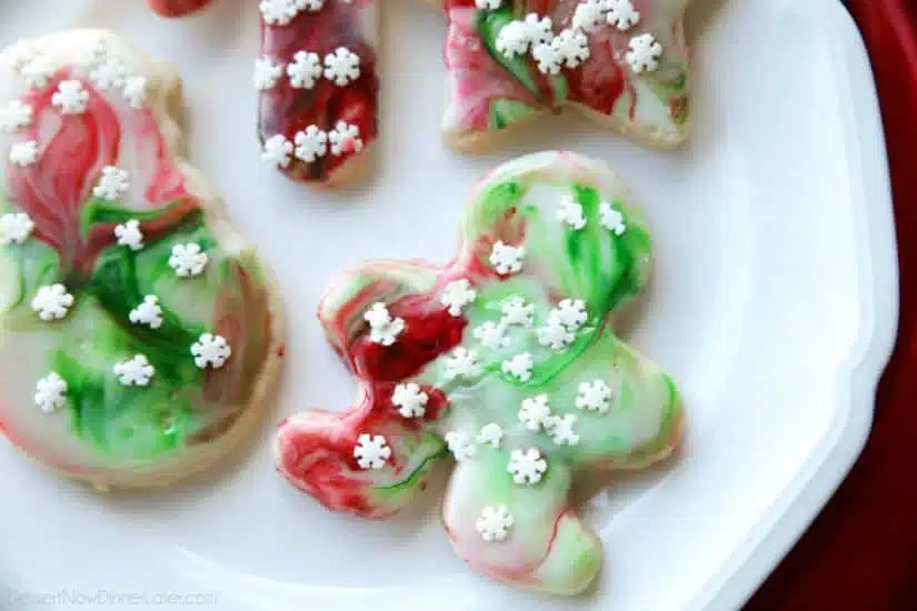 Swirled Christmas Sugar Cookies make cookie decorating easy! Simply swirl food coloring in a special glaze and dip the cookie! The kids will love making these for Santa! 