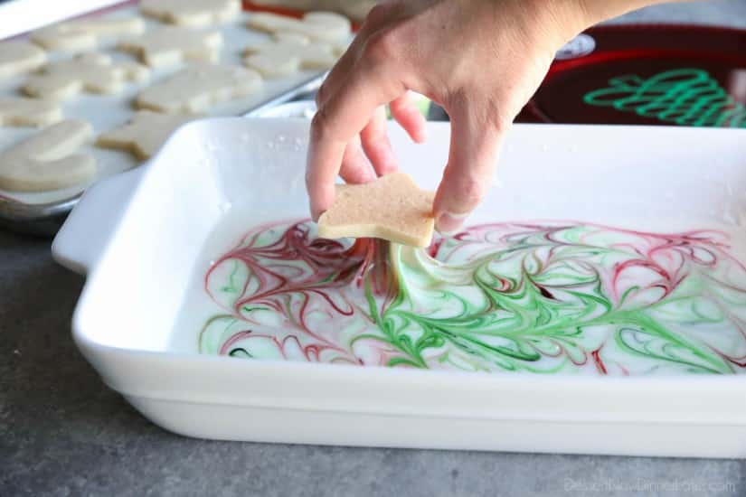 Swirled Christmas Sugar Cookies make cookie decorating easy! Simply swirl food coloring in a special glaze and dip the cookie! The kids will love making these for Santa! 