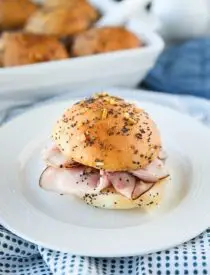 Ham and Cheese Sliders are baked in the oven with a buttery honey-mustard topping. Use leftover Christmas ham, or make them for dinner or game night. They're fast, easy, and feed a crowd!