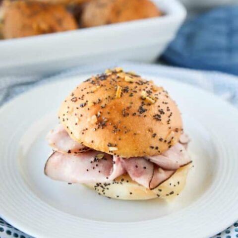 Ham and Cheese Sliders are baked in the oven with a buttery honey-mustard topping. Use leftover Christmas ham, or make them for dinner or game night. They're fast, easy, and feed a crowd!