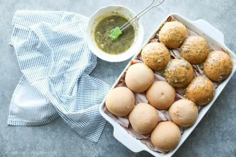 Ham and Cheese Sliders are baked in the oven with a buttery honey-mustard topping. Use leftover Christmas ham, or make them for dinner or game night. They're fast, easy, and feed a crowd!