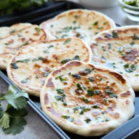 This buttery Garlic Naan flatbread is made easy with store-bought frozen dough. Enjoy restaurant-style Indian bread with dinner anytime, it's so easy!