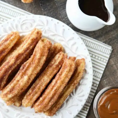 This churros recipe is super easy to make with a simple churro dough that is piped into oil and fried, then coated in cinnamon-sugar. You can enjoy these crisp, yet soft homemade churros anytime!