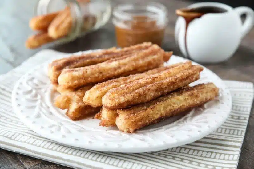 This churros recipe is super easy to make with a simple churro dough that is piped into oil and fried, then coated in cinnamon-sugar. You can enjoy these crisp, yet soft homemade churros anytime!