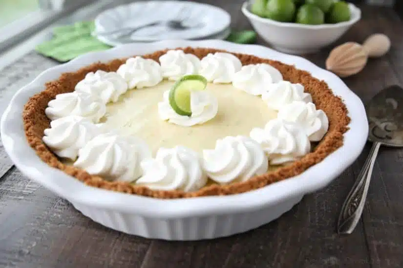 This classic Key Lime Pie recipe is smooth and creamy, tart yet sweet, and super easy to make! Top it with freshly sweetened whipped cream for the perfect bite!