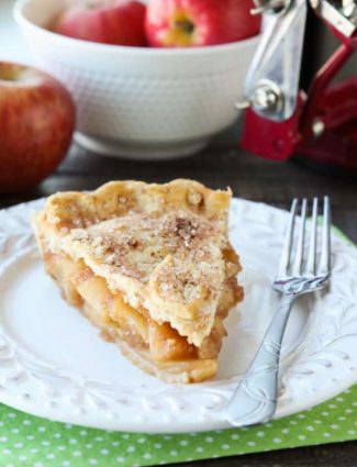 This homemade apple pie recipe has a flaky pie crust with cinnamon-sugar sprinkled on top and an extra fruity apple pie filling with just the right amount of sauce.