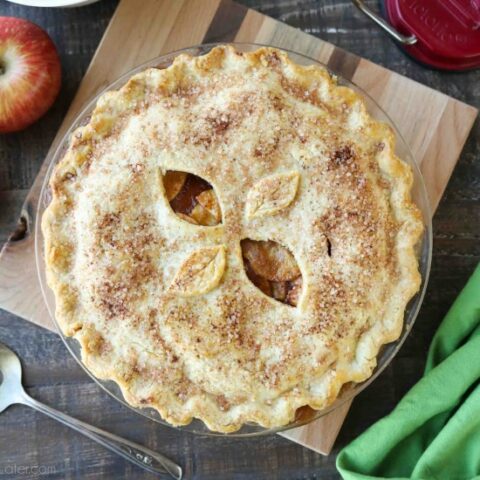 This homemade apple pie recipe has a flaky pie crust with cinnamon-sugar sprinkled on top and an extra fruity apple pie filling with just the right amount of sauce.