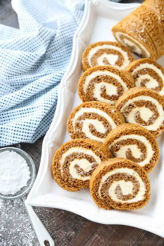 This classic Pumpkin Roll is a simple spiced pumpkin cake rolled up with the BEST cream cheese frosting inside. Use parchment paper for easy rolling -- no towel needed.