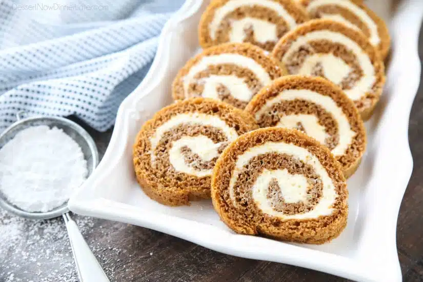 This classic Pumpkin Roll is a simple spiced pumpkin cake rolled up with the BEST cream cheese frosting inside. Use parchment paper for easy rolling -- no towel needed.